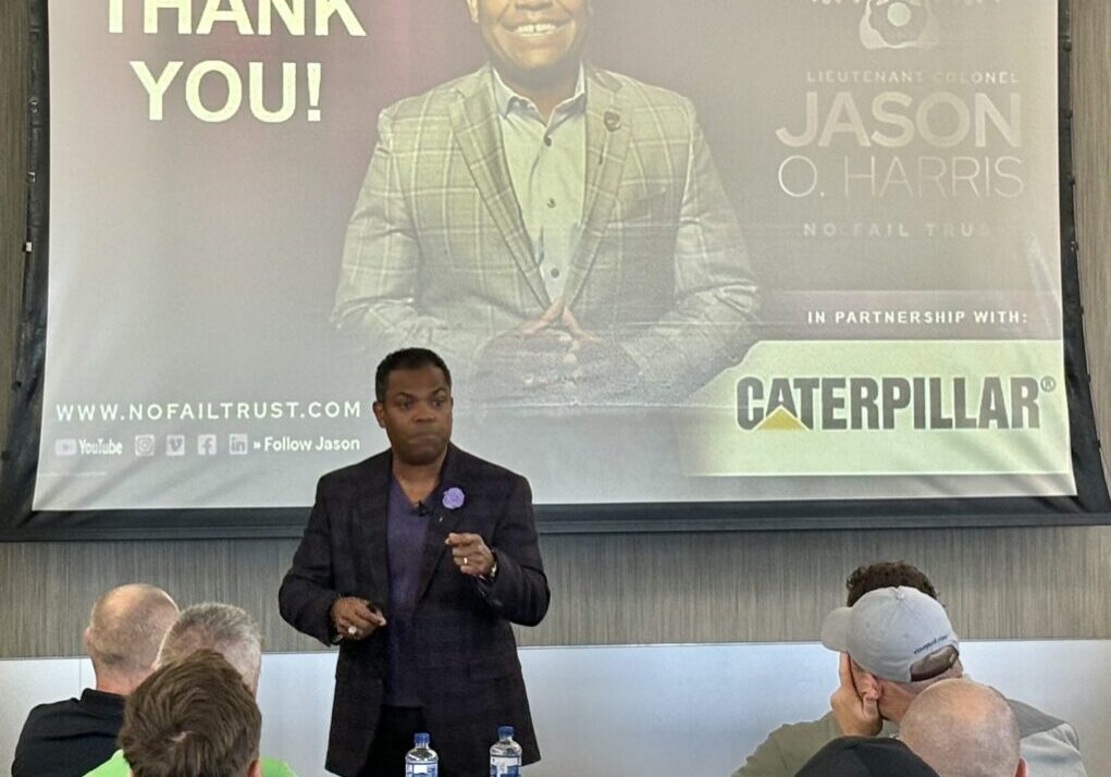 Jason Harris speaking to manufacturing leaders at Caterpillar